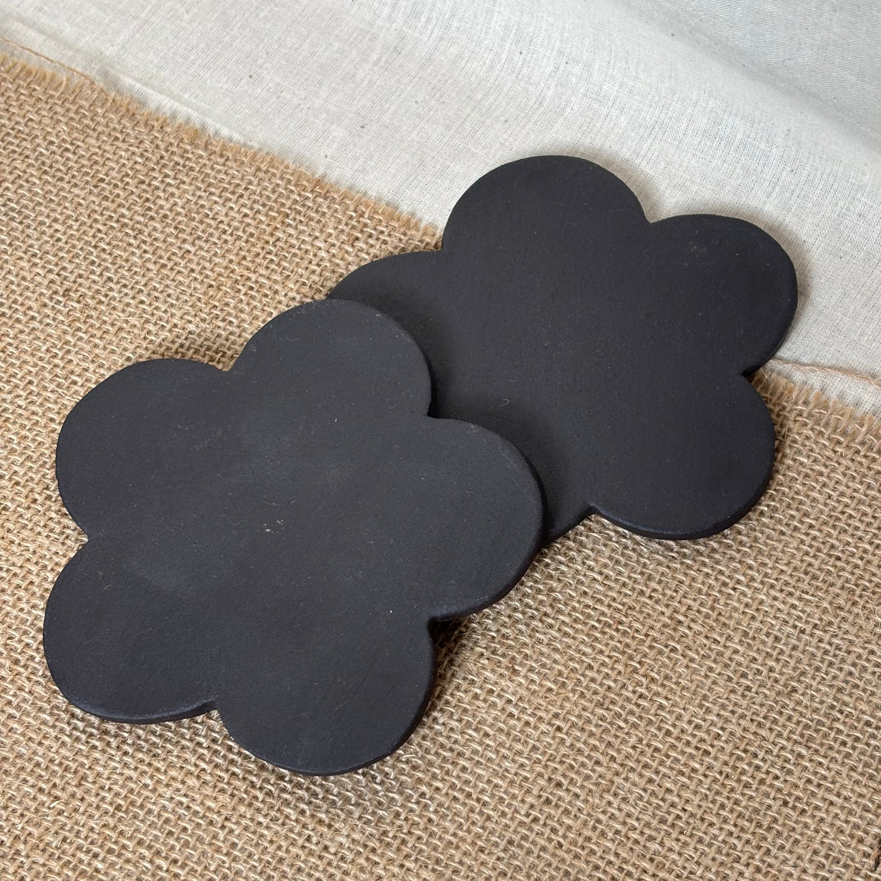 flower shaped coasters made with black clay