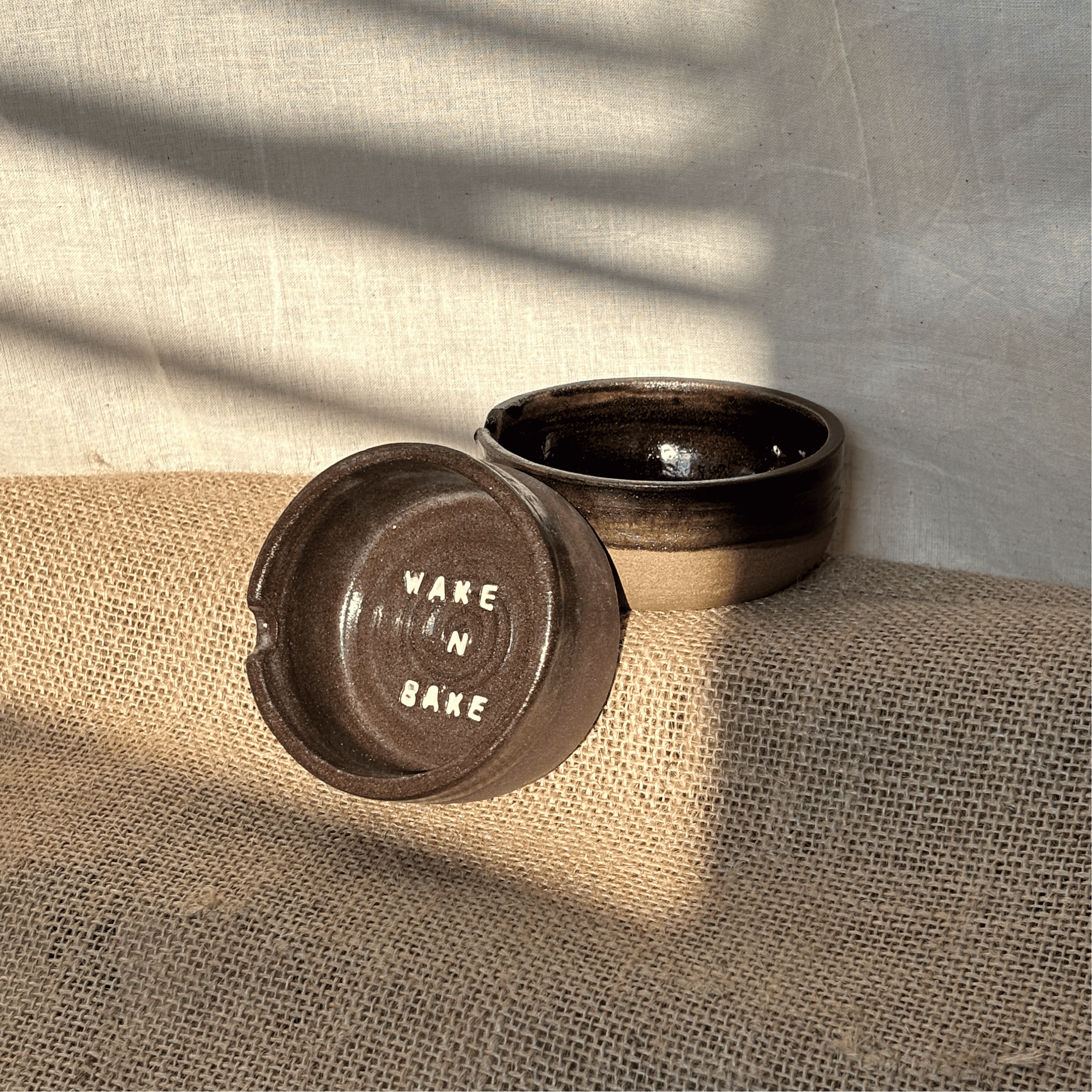 black ashtray with the quote wake n bake in white
