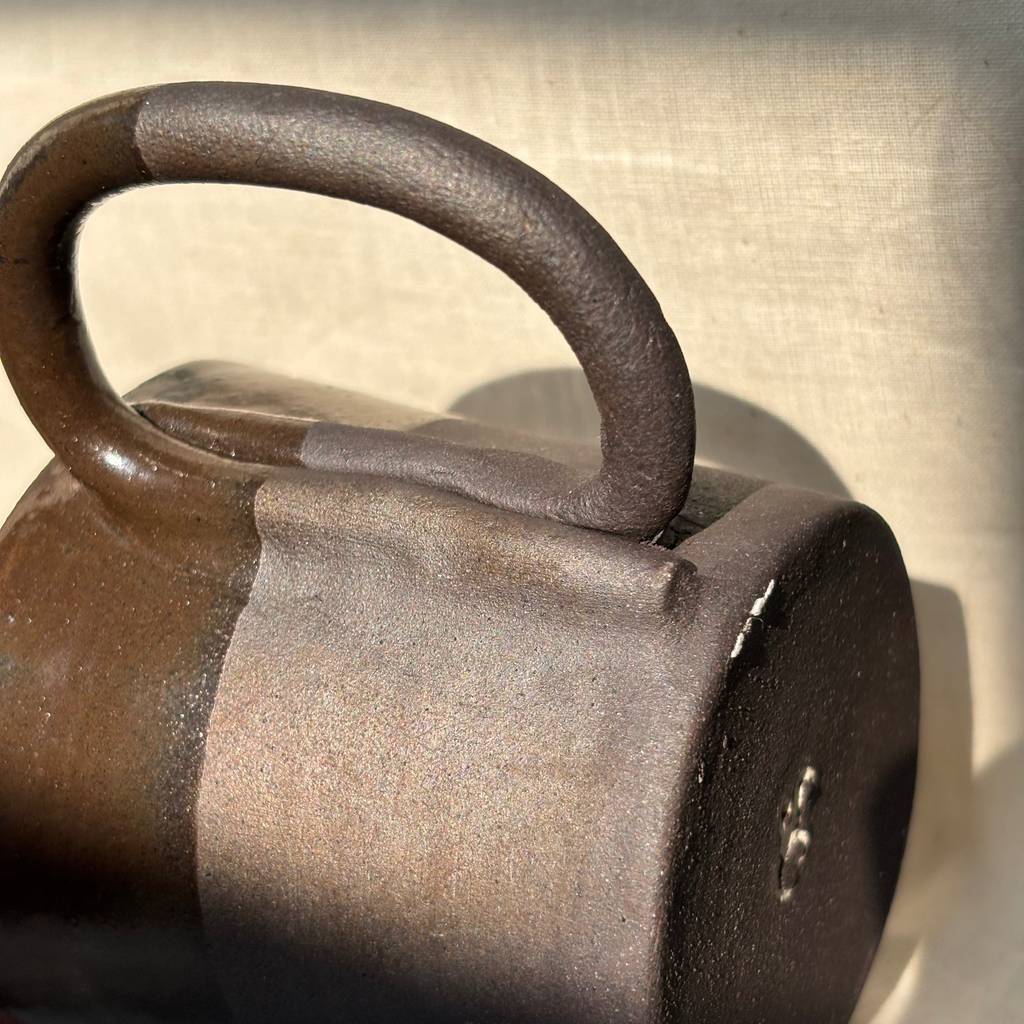 black ceramic mug with a handle