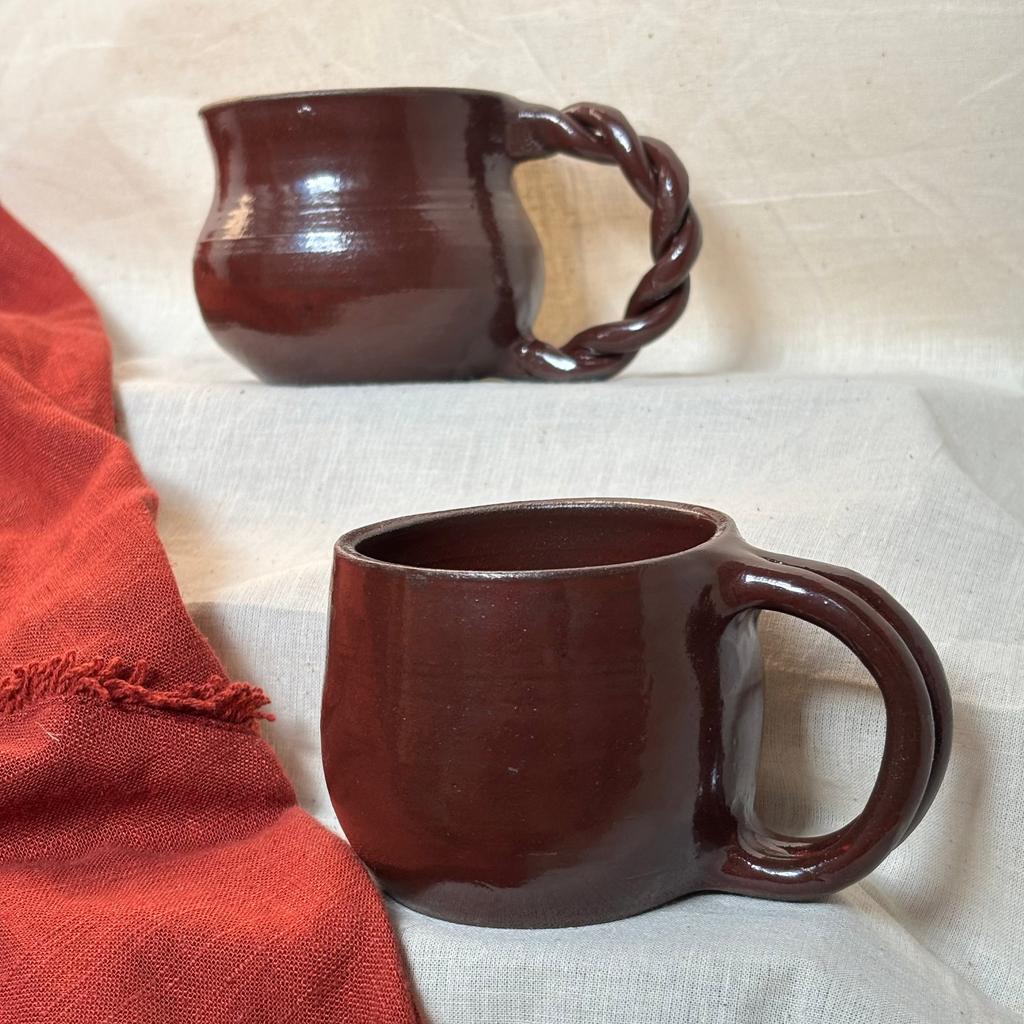 Red/maroon ceramic cups with different handles